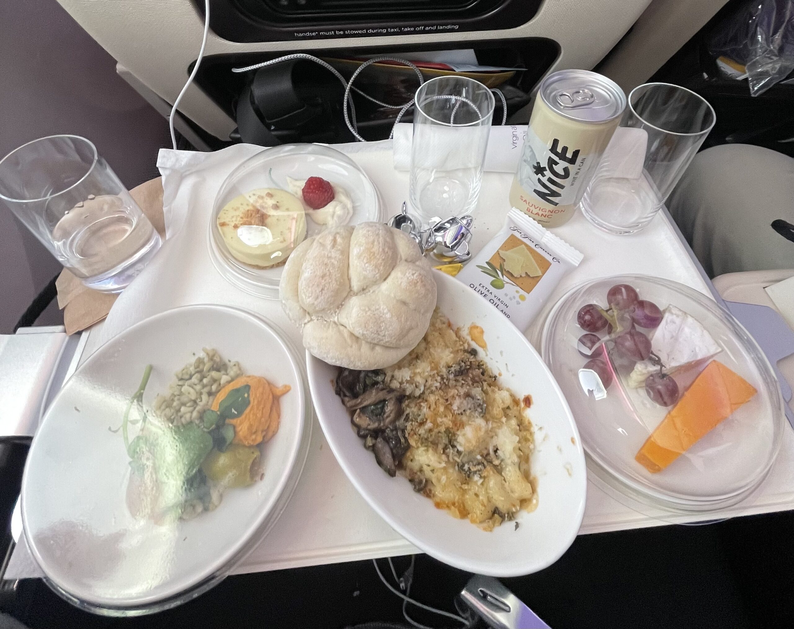 Alt Text: Photo taken in .5 of the mac and cheese, roll, fruit and cheese, side dish, dessert, and drink mentioned in the story. (Photo Credit: Emma Gannon, 2024)